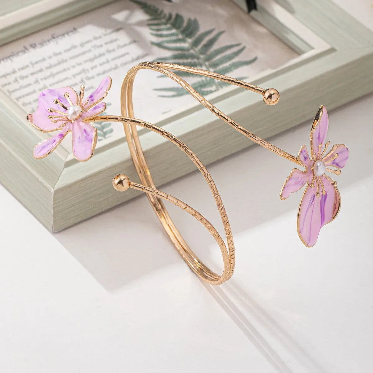 Pink alloy armband with hollow pattern design showing adjustable sizing and cut-out details