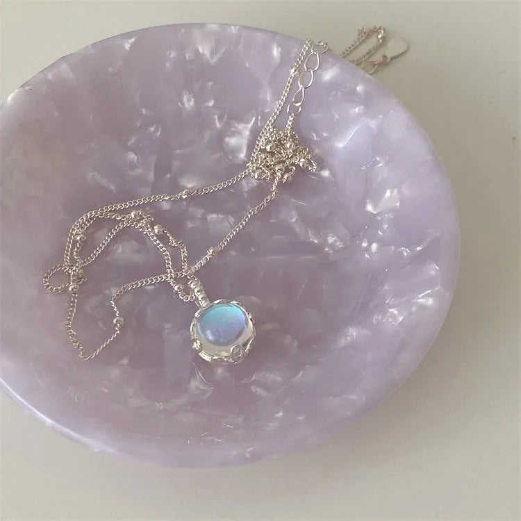 Silver necklace with geometrical ornamental stone pendant on an adjustable curb chain.