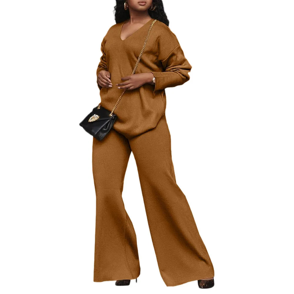 Women's brown suede two-piece suit with split sleeve detail on the long-sleeved top and matching trousers.