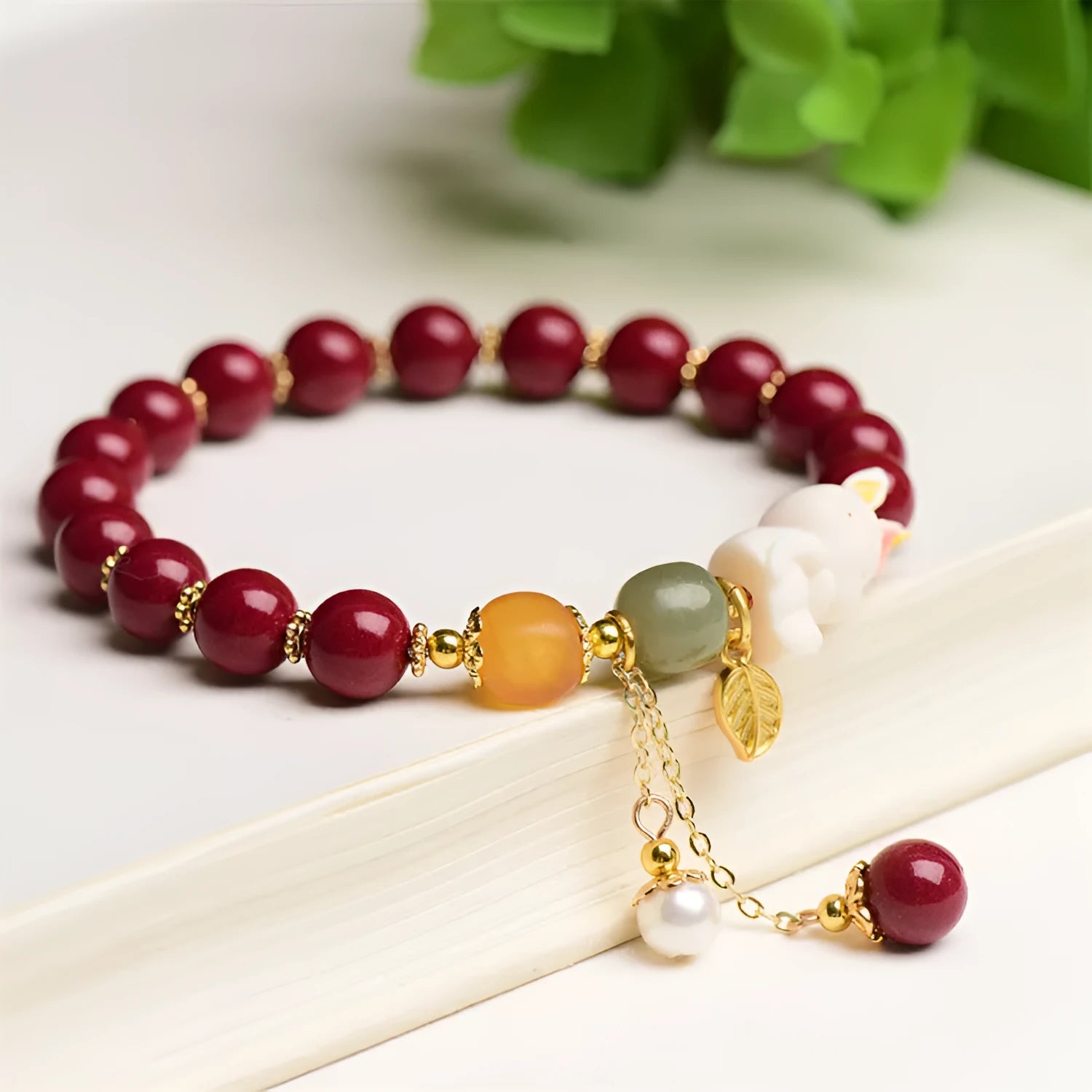 Natural beeswax purple gold sand bracelet with a detailed hand-carved cinnabar rabbit charm.