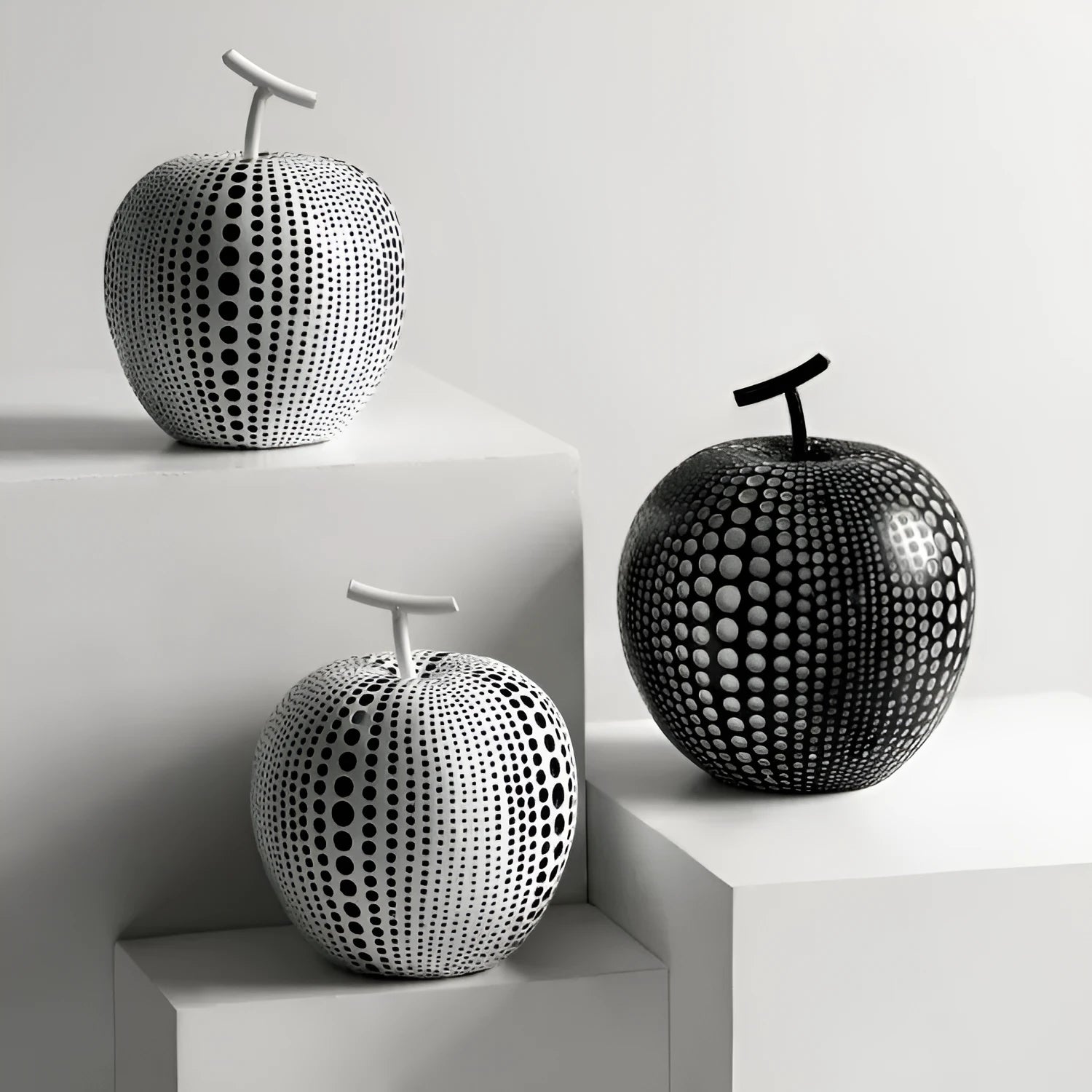 Resin decorative crafts set showing high black apple and low white pear sculptures