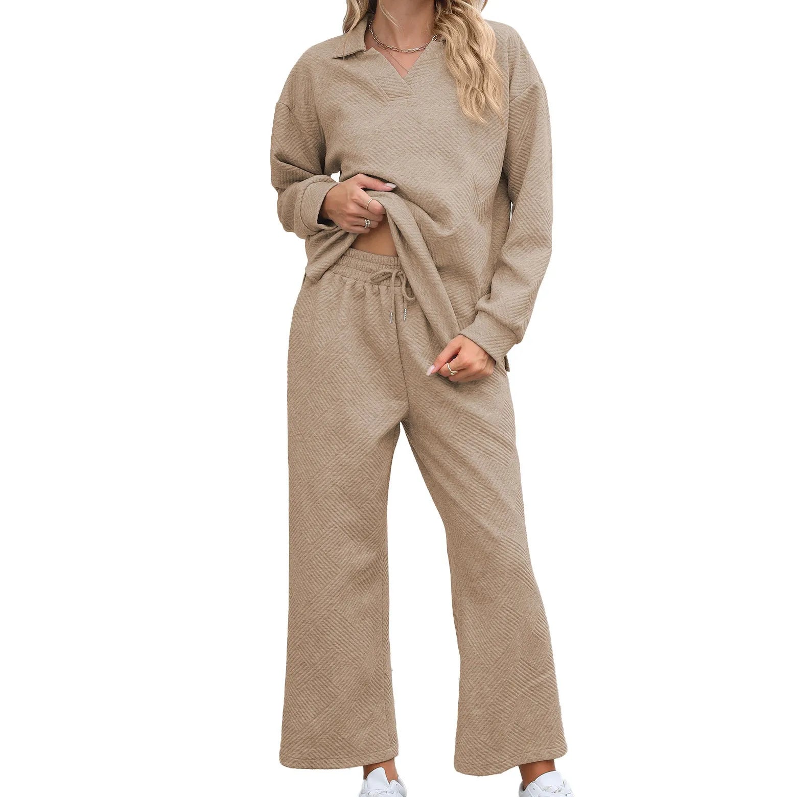 Women's black geometric pattern knitted suit set with long sleeve top and elastic waist cropped trousers.
