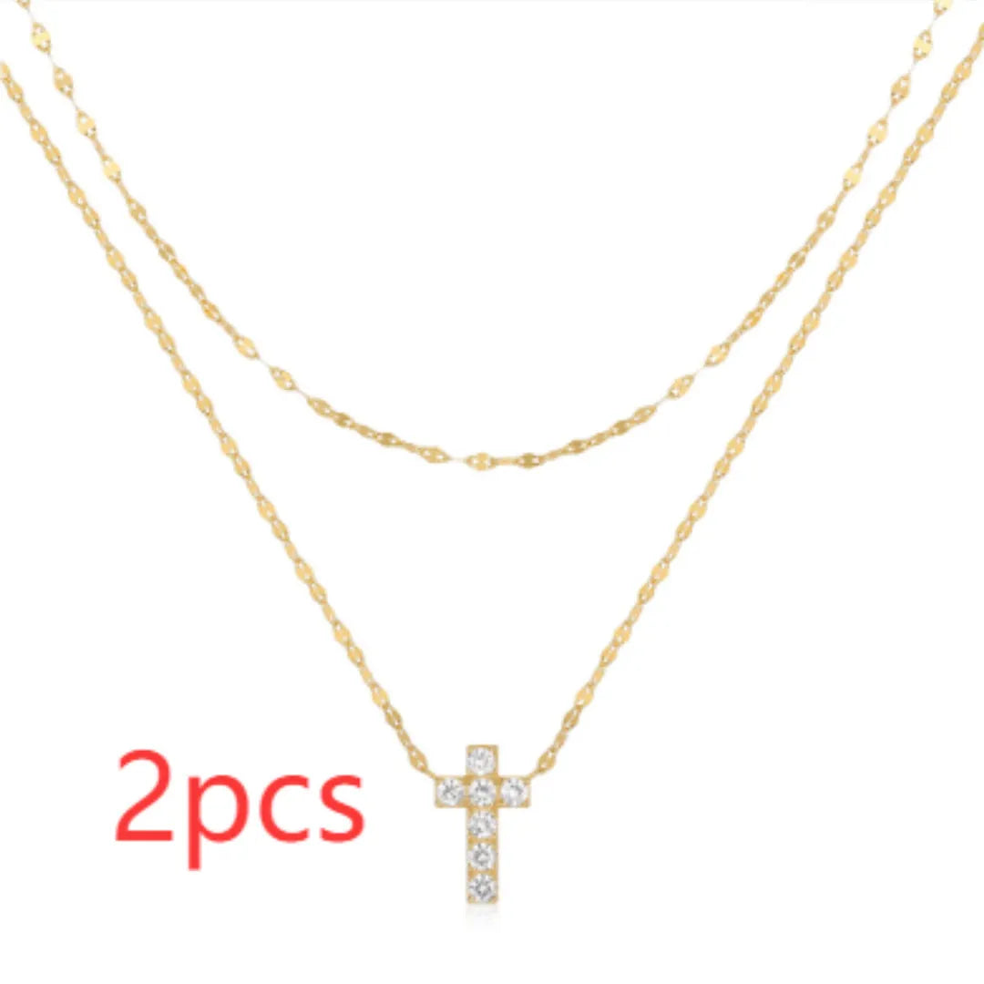 S925 sterling silver double layer cross pendant necklace with diamond accents on a clavicle chain.