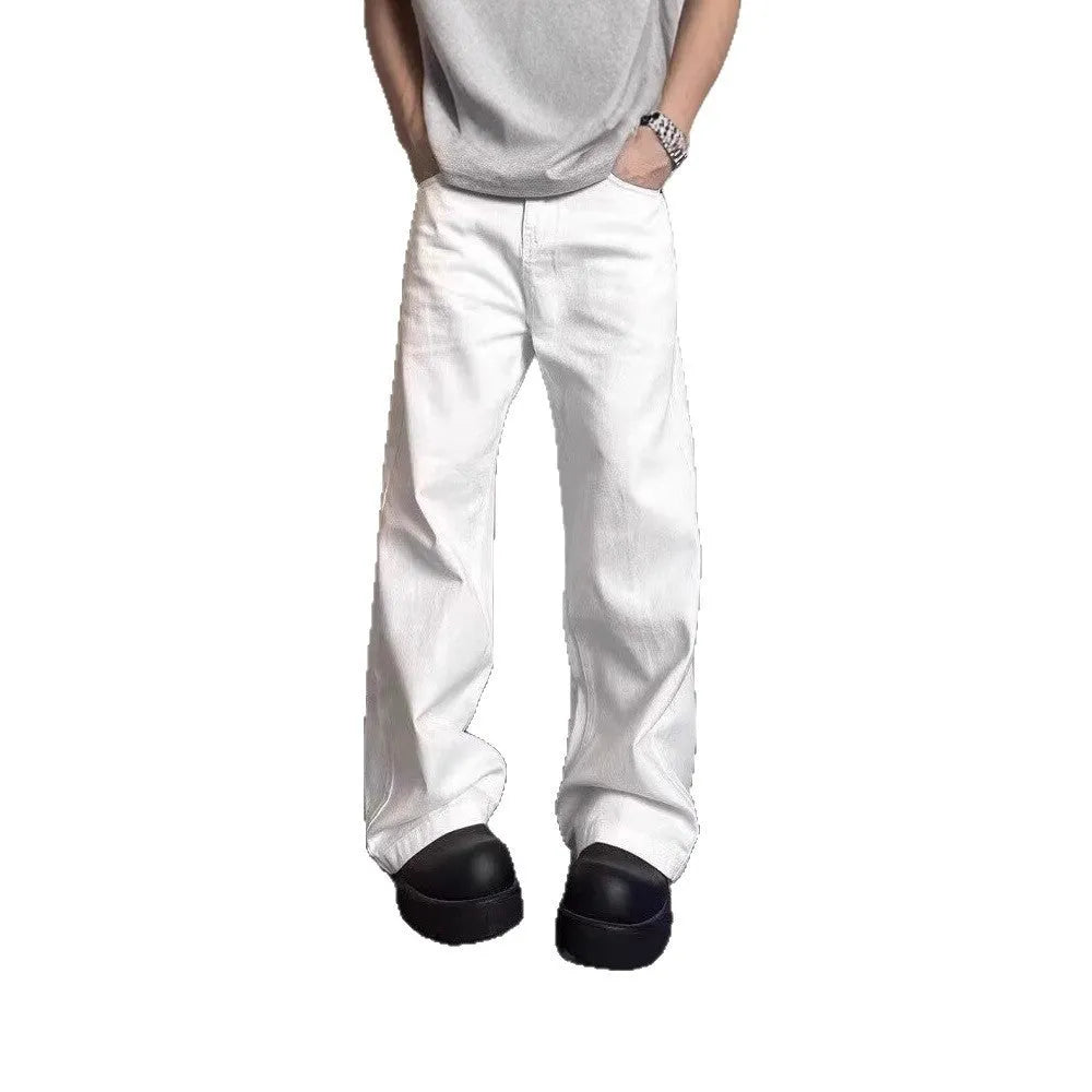 A pair of men's white wide-leg straight jeans with a mid-rise waist and zipper fly on a plain background.