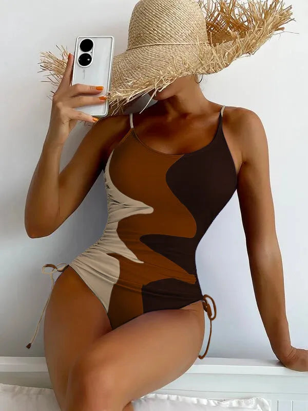 Women's sleeveless backless one-piece swimsuit in a striped pattern, shown in blue.