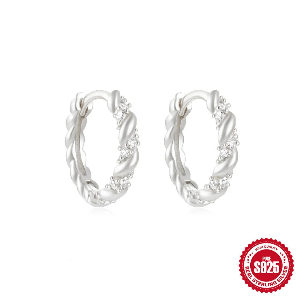 Small round geometric sterling silver stud earrings with a diamond shape, available in gold or silver finish.