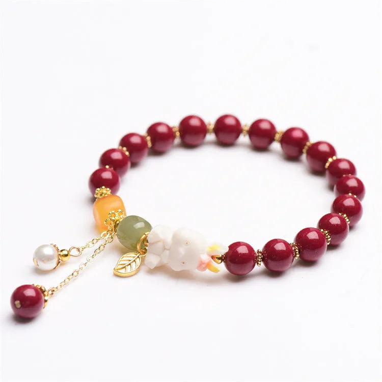 Natural beeswax purple gold sand bracelet with a detailed hand-carved cinnabar rabbit charm.