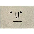 Mr. Big Nose cartoon facial expression PVC floor mat with geometric pattern in a square shape on a home floor.
