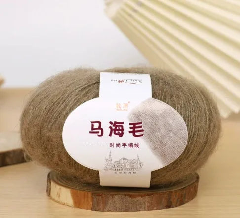DIY mohair scarf weaving kit showing one wool ball and a selection of 34 colour options including white, pink, blue and green.