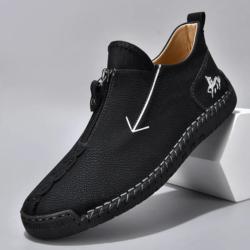 Men's black casual ankle boots with a front zip closure and visible stitching detail