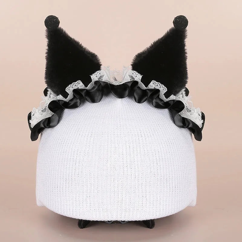 Plush fabric ski helmet decoration with cartoon design on a black ski helmet.
