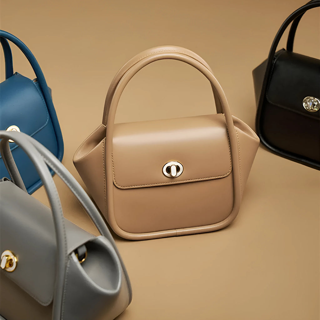 Soft cow leather wing-shaped tote handbag with a buckle and cross-body strap in four colour options.