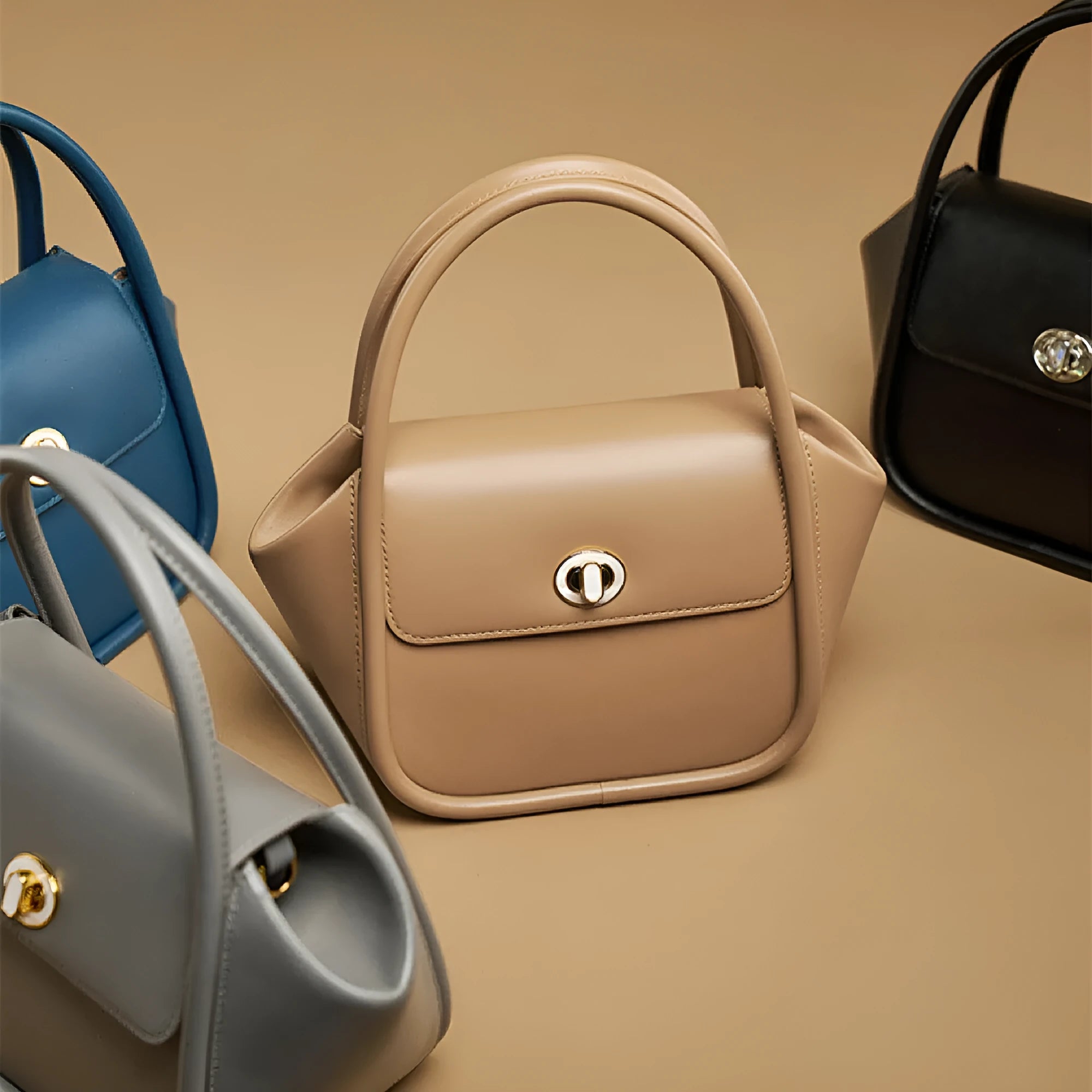 Soft cow leather wing-shaped tote handbag with a buckle and cross-body strap in four colour options.