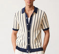 Men's white short sleeve knitted shirt with an asymmetric lapel, laid flat.
