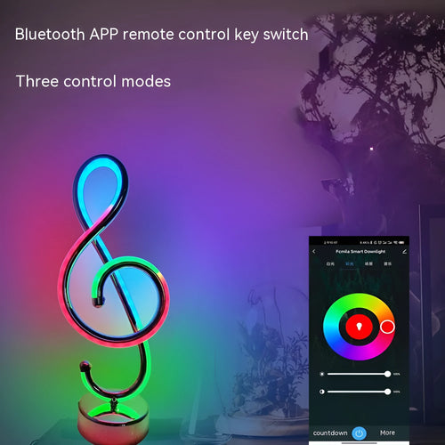 Black musical note shaped Bluetooth light with remote control on a bedside table.