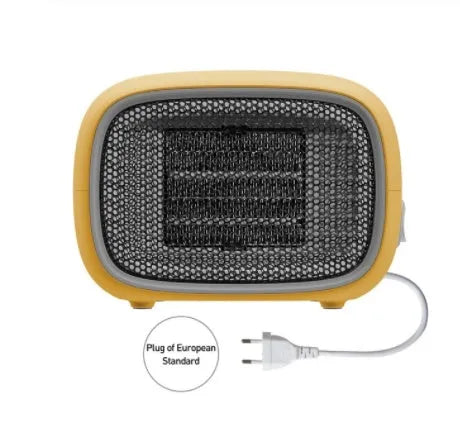 Compact green portable ceramic fan heater with metal grille, shown on a desk