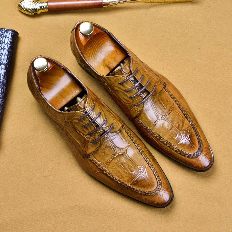 Men's brown leather loafers with a silver horse bit buckle on a rubber sole.