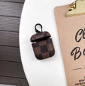 IPhone XS Max hard plastic case with grid pattern and anti-lost hook, next to a compatible AirPods 2 leather charging case.