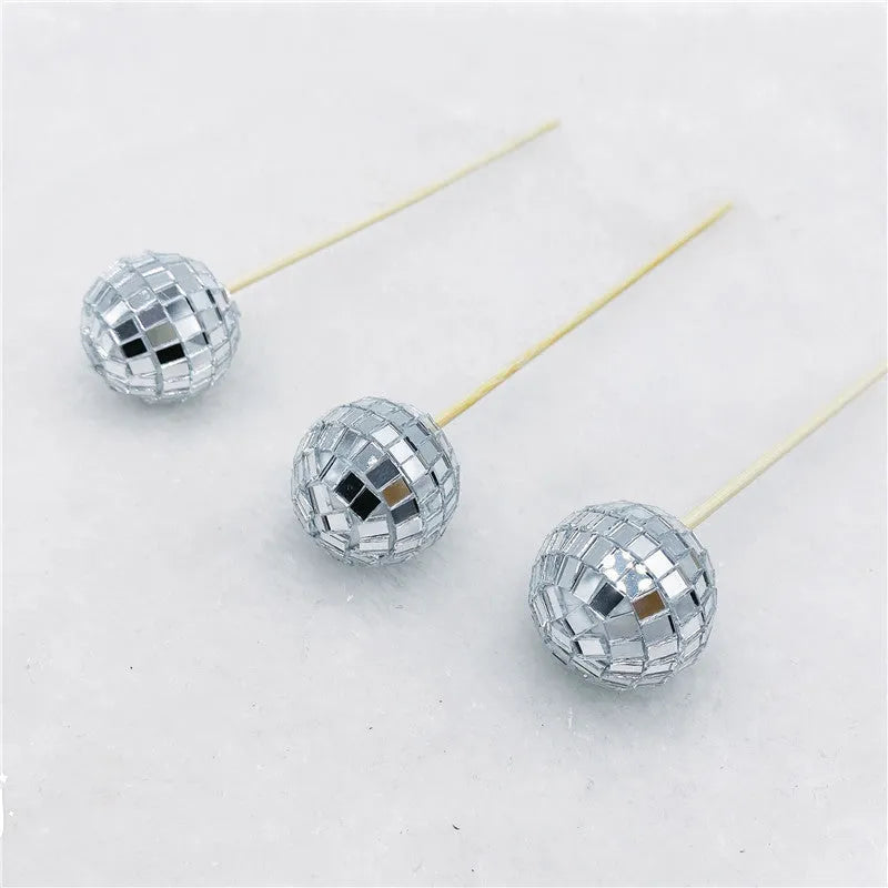 Glass disco ball cake decoration on a wooden stick, shown in different sizes for birthday cakes.