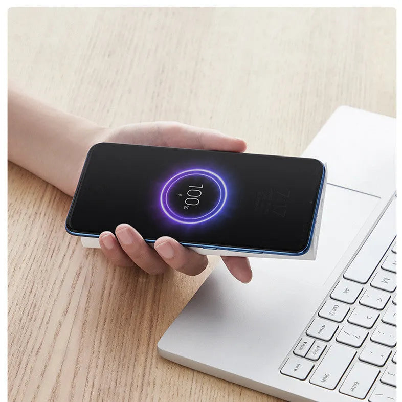 White large capacity 10000mAh power bank with USB port on a wooden table