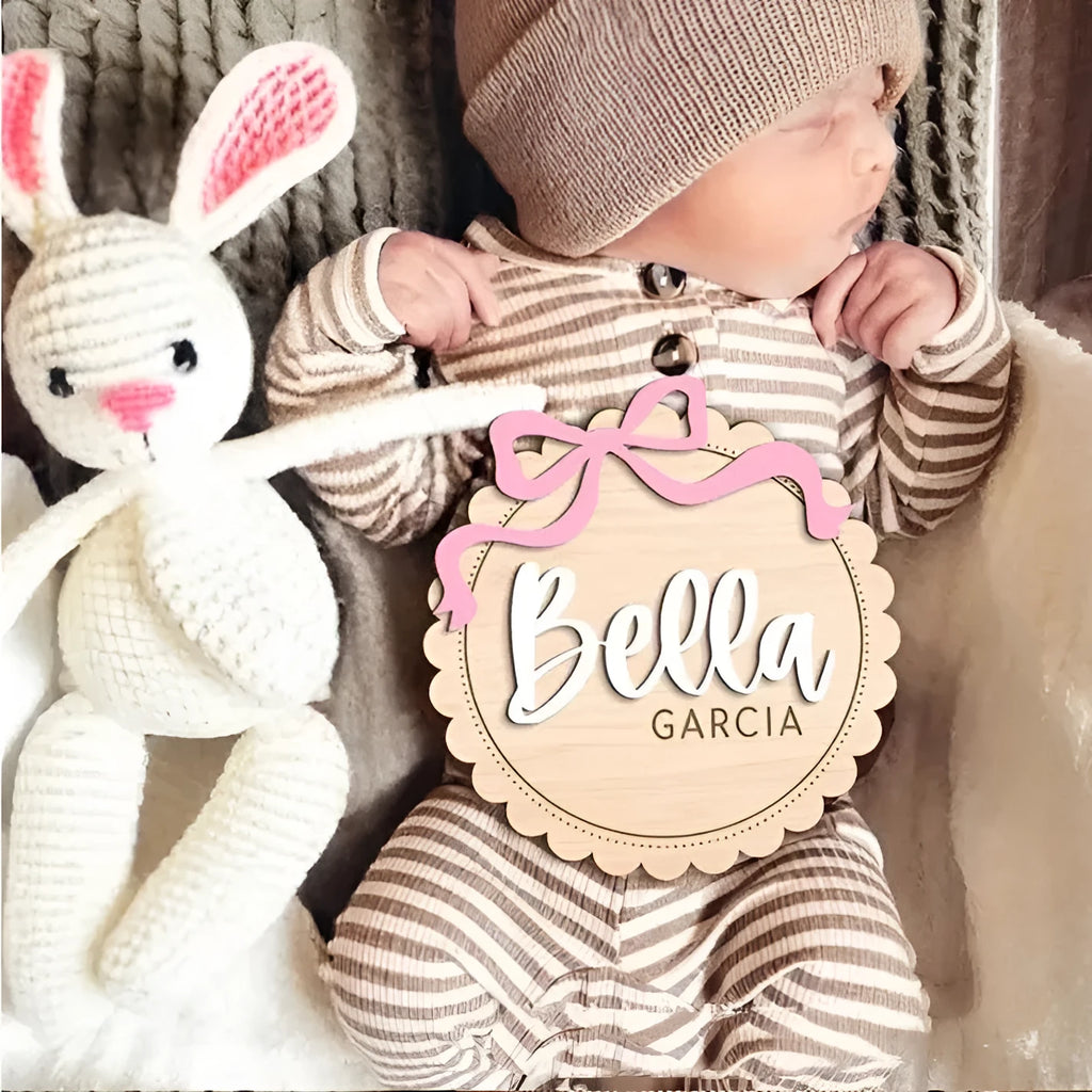 Square wooden baby room ornament with a custom engraved name, shown in two size options.