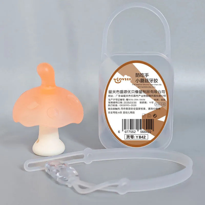 Small mushroom-shaped pink chewing gum inside a transparent box with a silver chain attached.