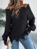 A woman wearing a white hollow-out cut off-the-shoulder pullover sweater in a street fashion style.