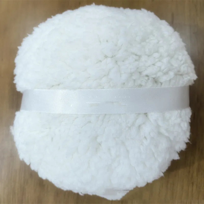 Oversized white plush powder puff measuring 150mm by 75mm for makeup application