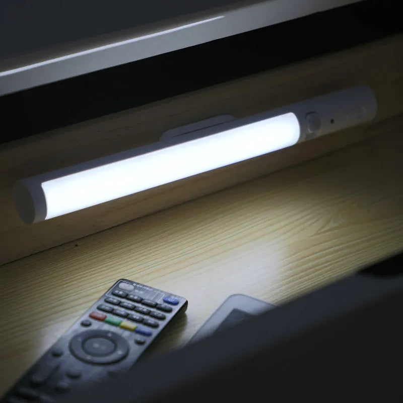 A slim 260mm long white LED strip light with a magnetic back for cabinet mounting.
