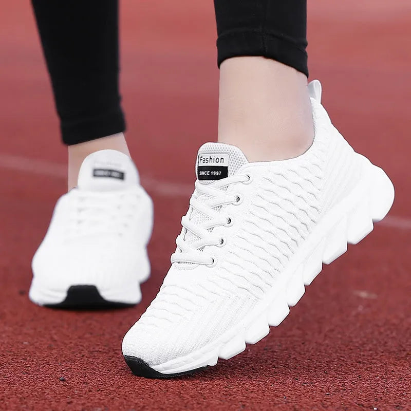 Women's running shoes in black, pink, or white with a detailed fly weaving upper and durable outsole.