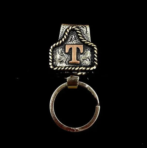 Handmade metal cow tag belt key holder keychain on a key ring, showing the metal loop and tag design.