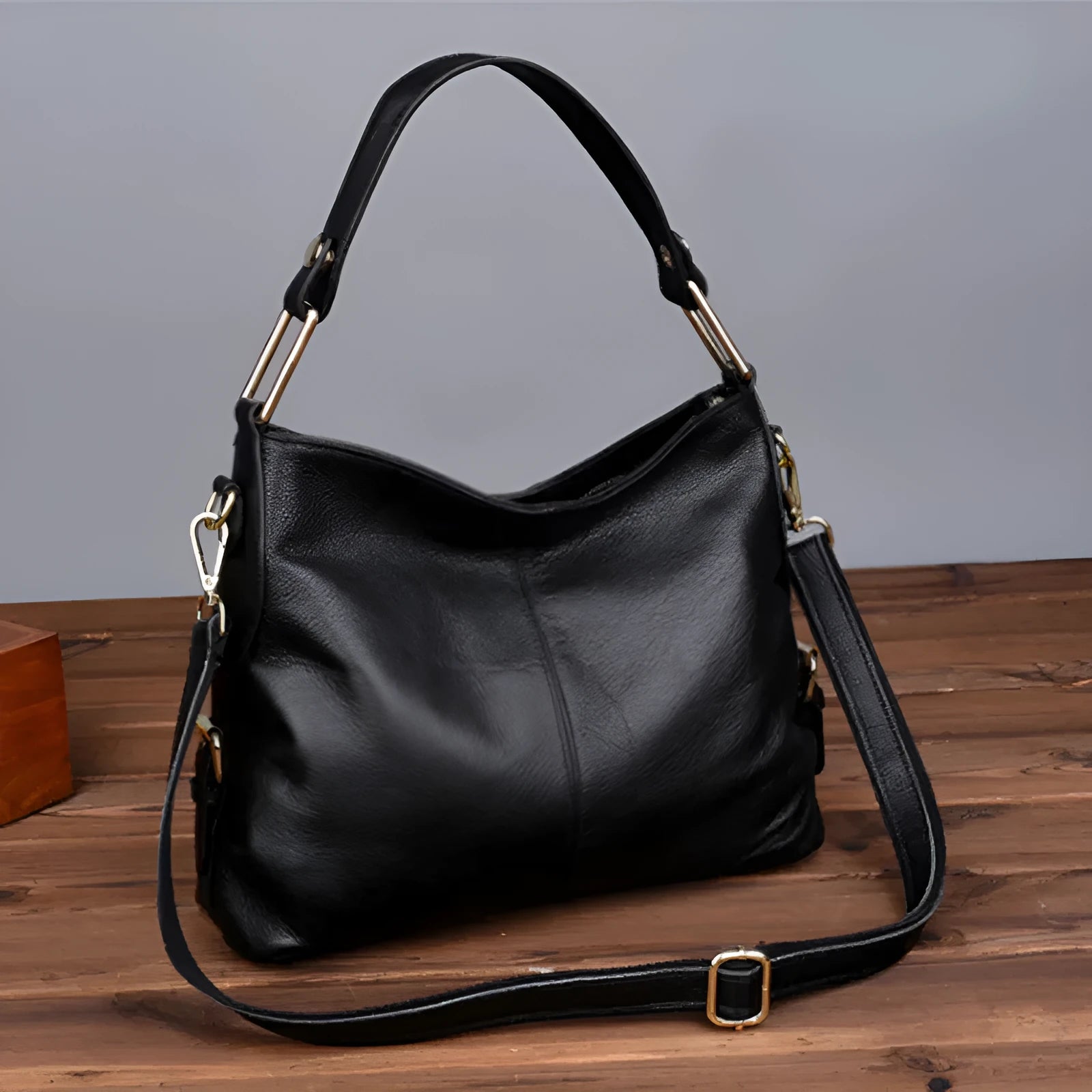 Square vertical genuine leather crossbody bag with multiple internal zipper compartments.