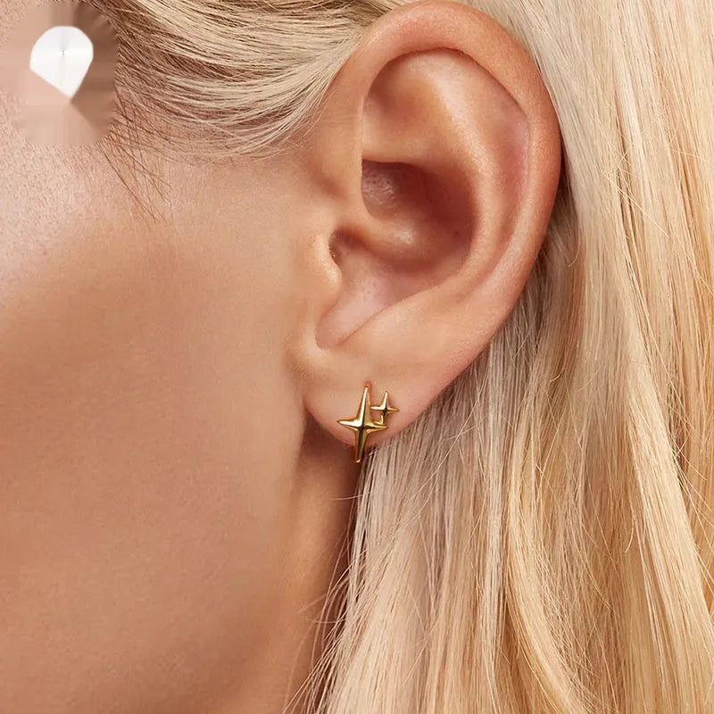 Minimalist sterling silver star clip earrings with oxidation treatment and XINGX celestial elements