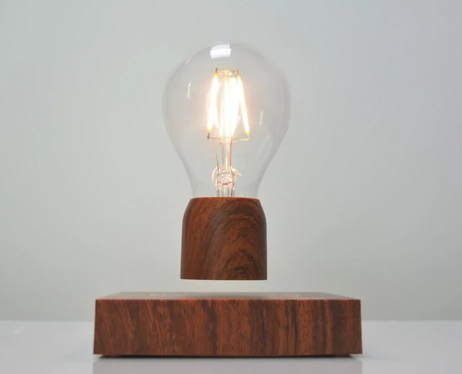 Magnetic levitation floating light bulb hovering above imitation wood base with universal voltage specification