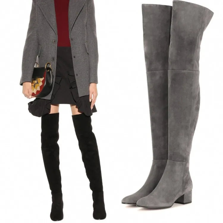 Women's grey suede over-the-knee flat boots with a pointed toe and thick low heel.