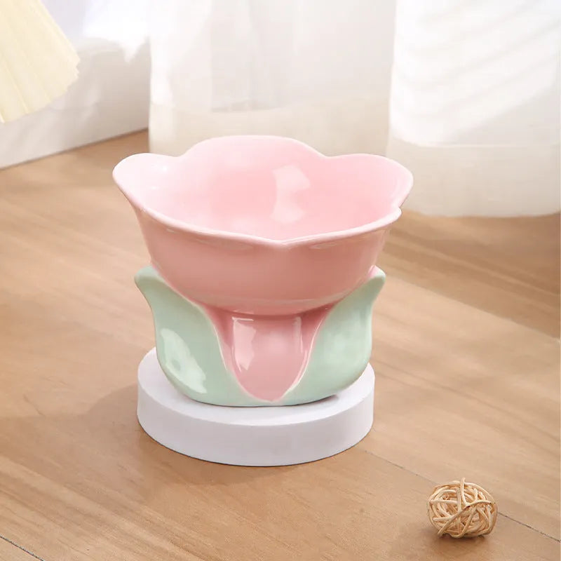 Blue ceramic elevated pet bowl with floral pattern and non-slip base for cats or small dogs.