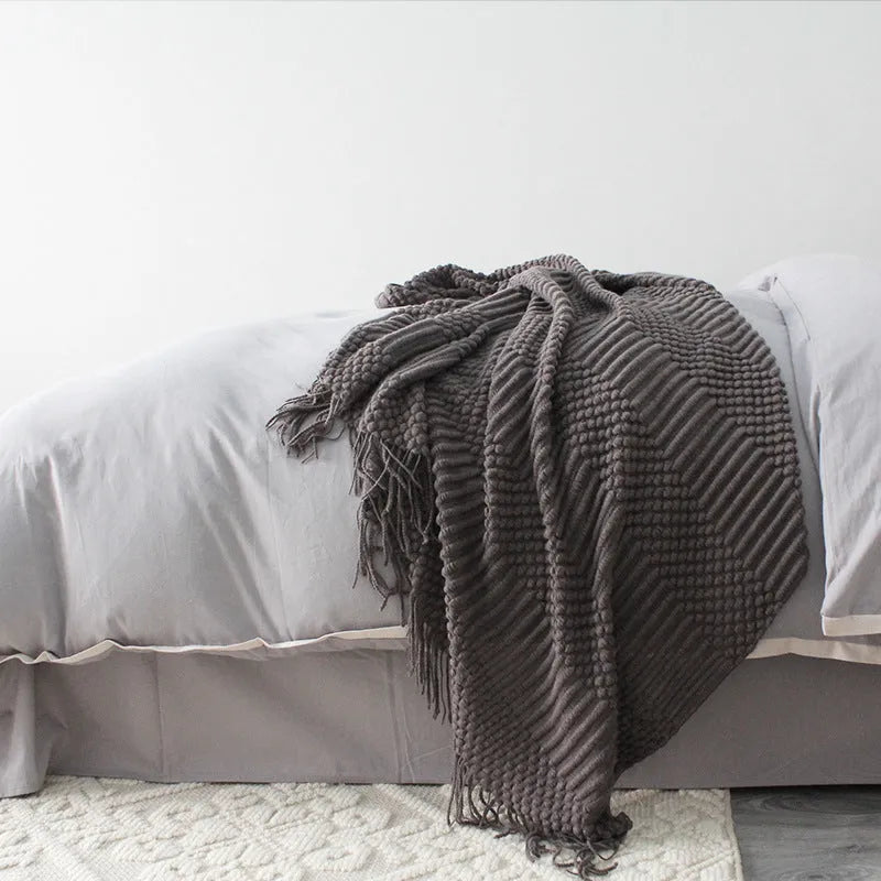 Small polyester fibre nap blanket measuring 127cm by 170cm in dark grey colour
