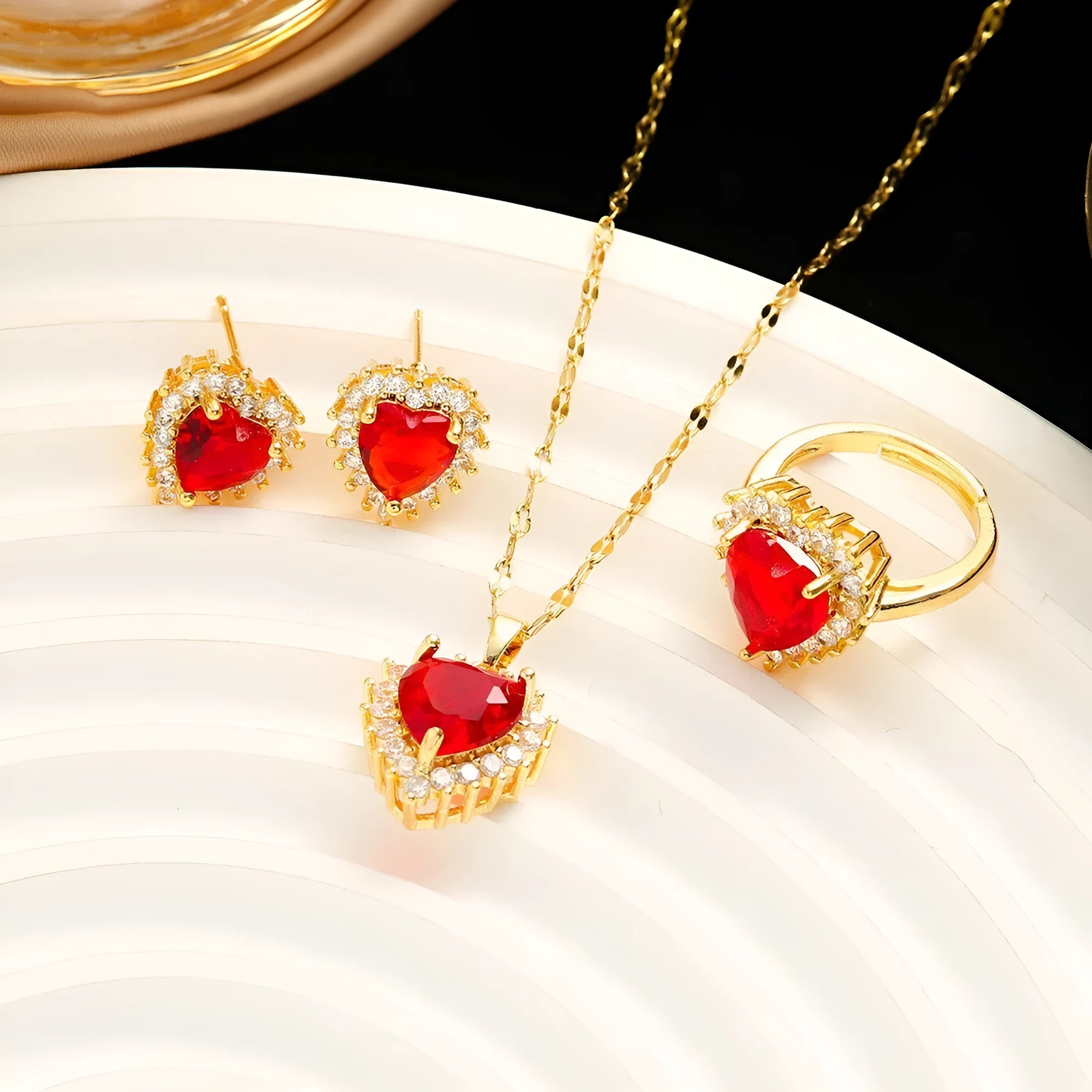 Gold red titanium steel necklace with hearts flower pendant and mixed gemstone inlay, matching ring and earrings.