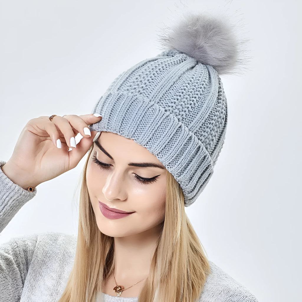 Wool knitted beanie hat with satin lining and faux fur pom pom in beige colour