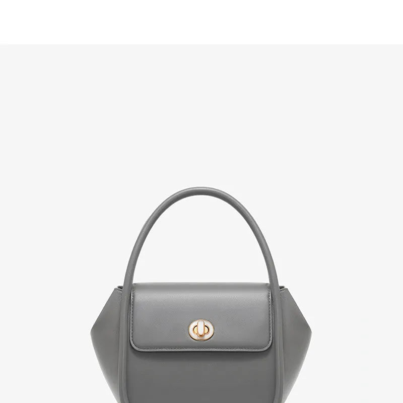 Soft cow leather wing-shaped tote handbag with a buckle and cross-body strap in four colour options.