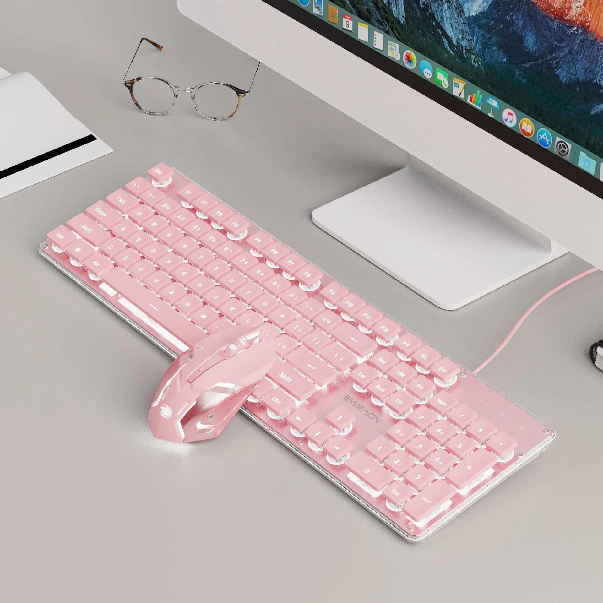 Wired computer keyboard with mute button and blue backlighting on a desk