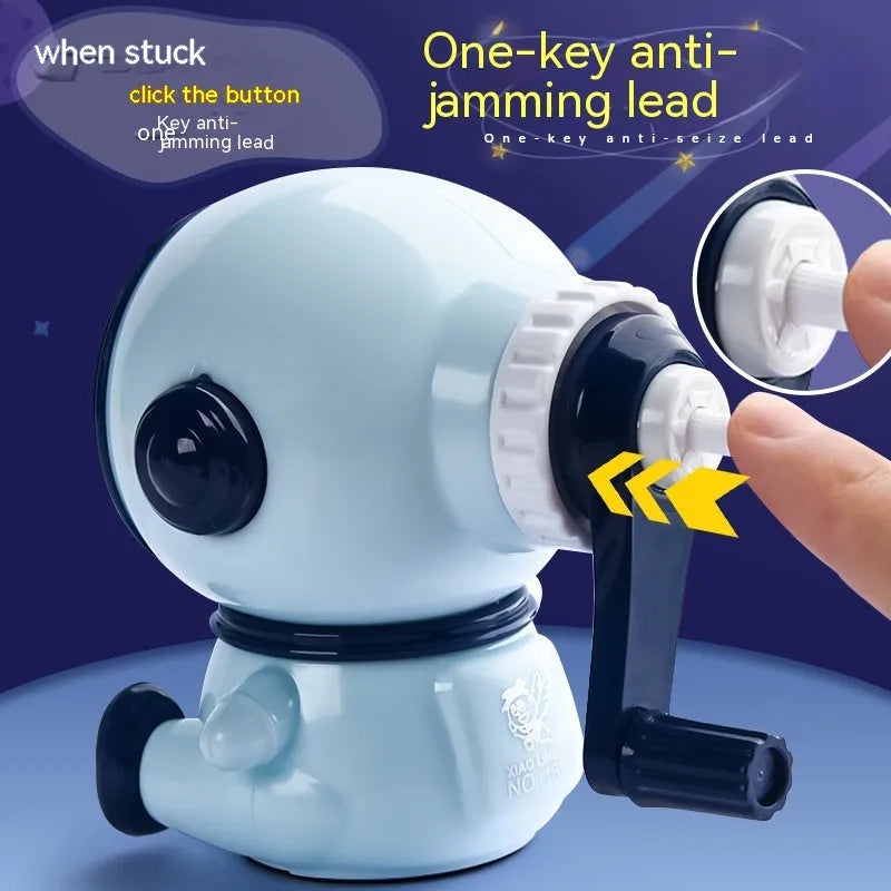 Blue and pink cartoon astronaut model manual pencil sharpener for children on a desk.