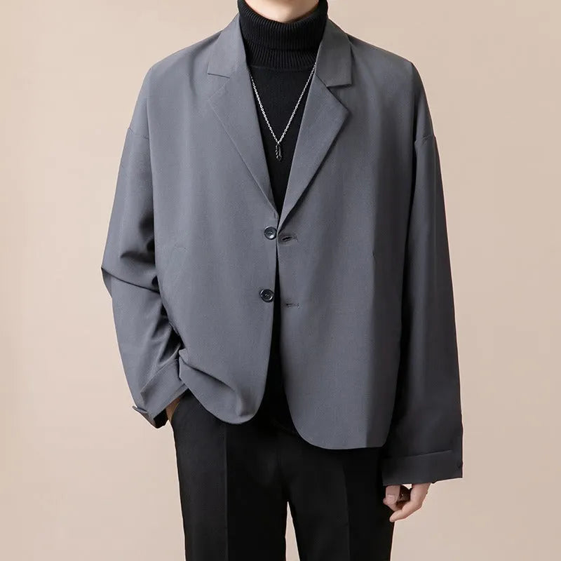 Man wearing a loose fit casual suit jacket in a light business style, available in apricot colour.