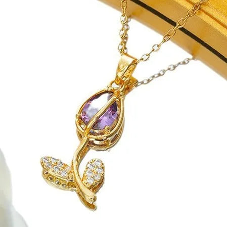Gold electroplated tulip flower pendant on an adjustable titanium steel necklace chain.