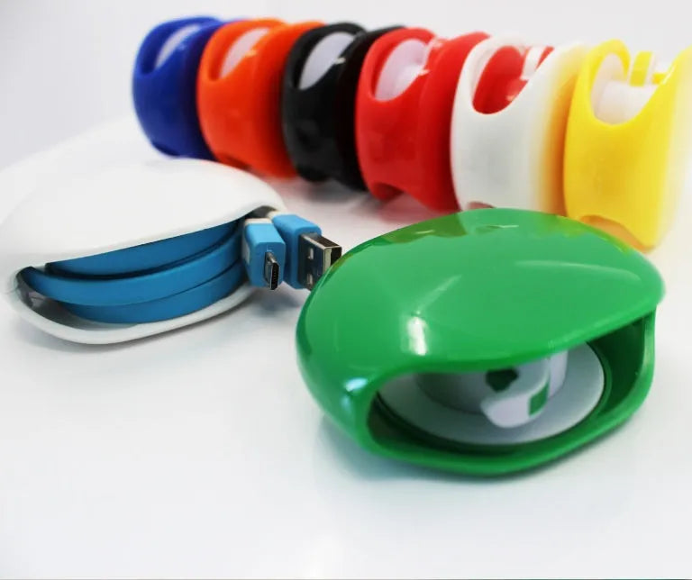 Automatic push-button earphone cable winder reel in assorted colours on a white background.