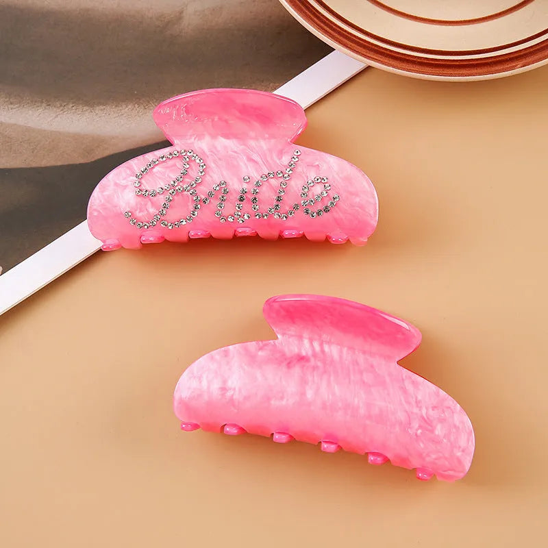 Pink and white acrylic barrette hair clip with diamond spot drilling and English letters.