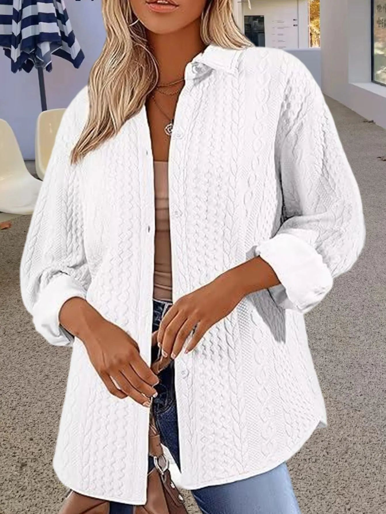 Women's solid colour long sleeve knitted cardigan sweater on a hanger.