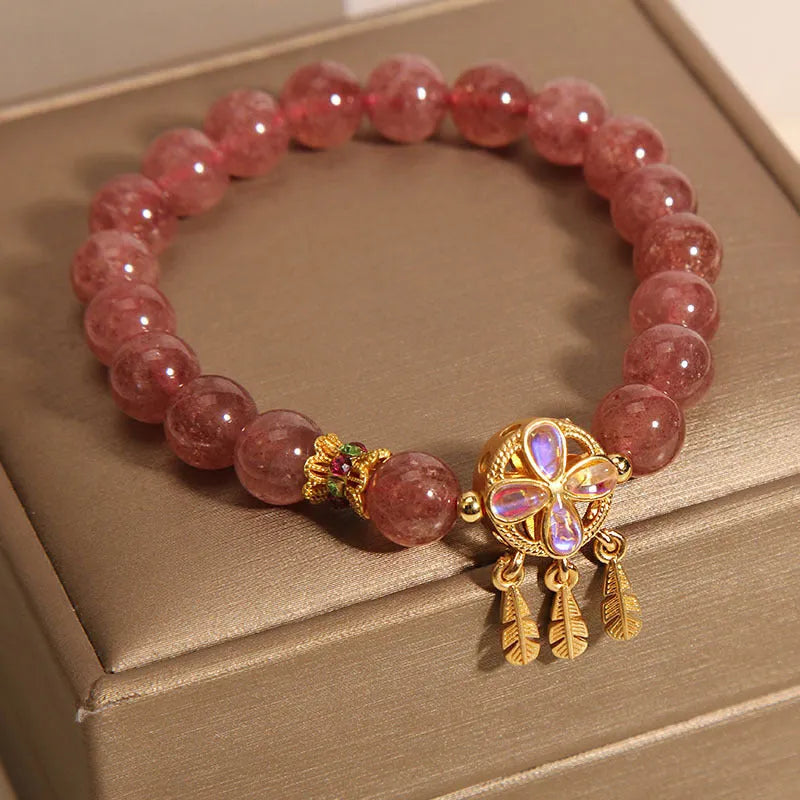 Women's strawberry quartz bracelet with four leaf clover dream catcher ball pendant