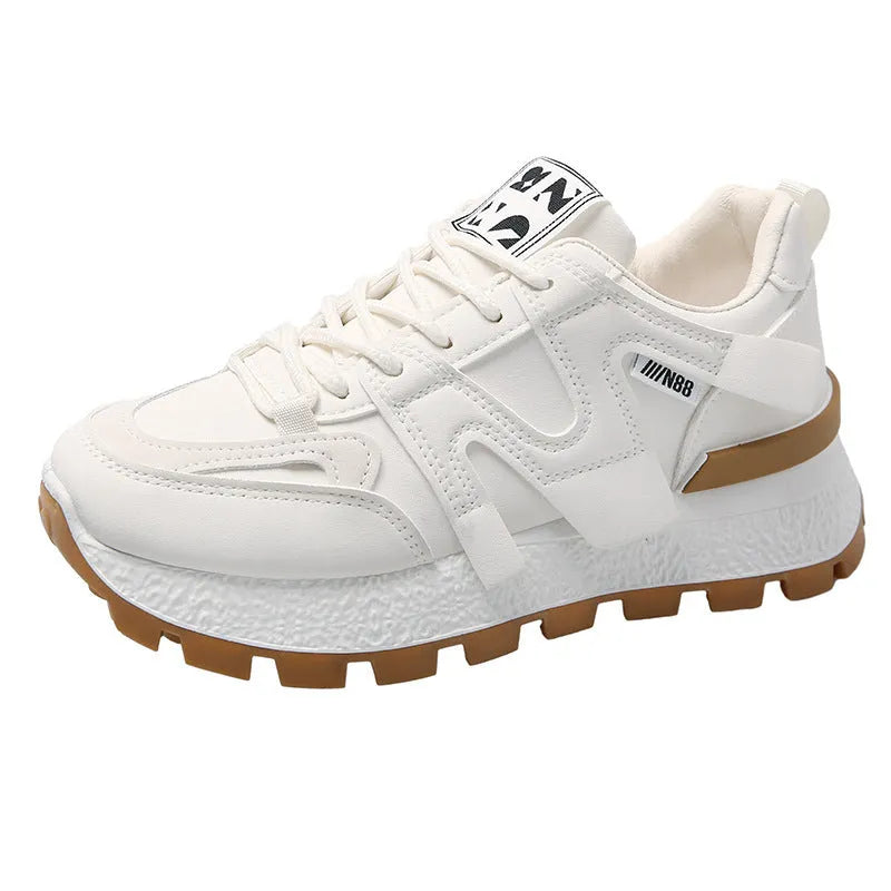 A pair of low-top black or white sneakers with a round toe, lace-up front, and flat rubber sole.