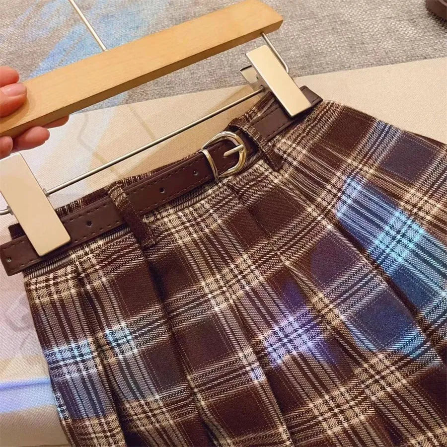 Girls' plaid pleated A-line skirt with an elastic waistband on a hanger.